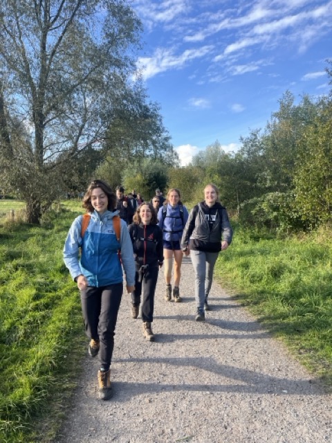 Het team wandelt over een landweg in de zon